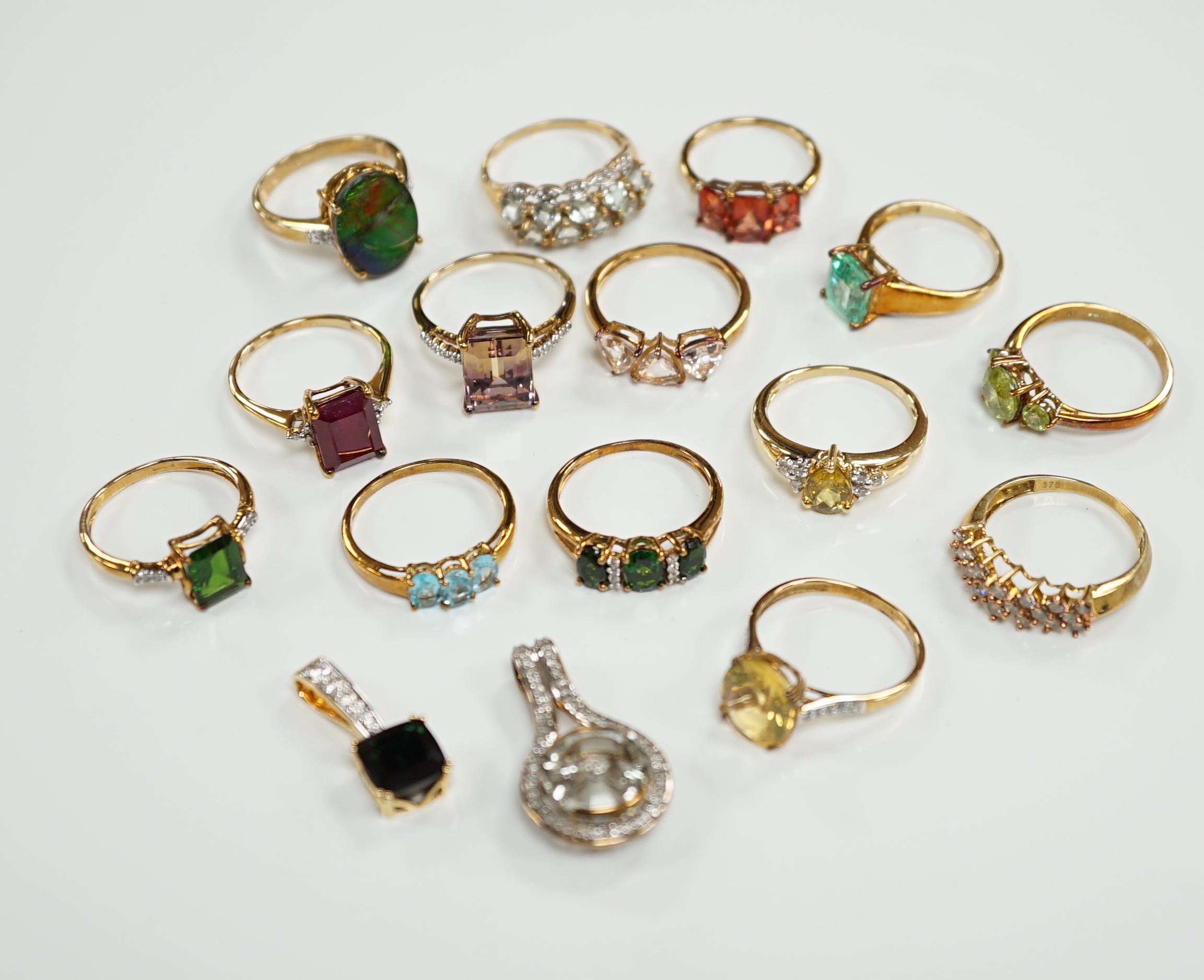 Thirteen assorted modern 9ct gold of 9k and gem set dress rings and a 9ct gold and gem set pendant, gross weight 40.2 grams, together with an 18ct gold, gem and diamond chip set target pendant and an 18ct gold and gem se